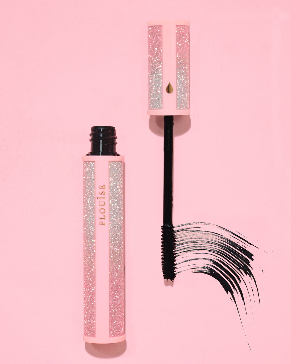 Pink glittery P.Louise Cry Baby mascara with black wand on a pink background