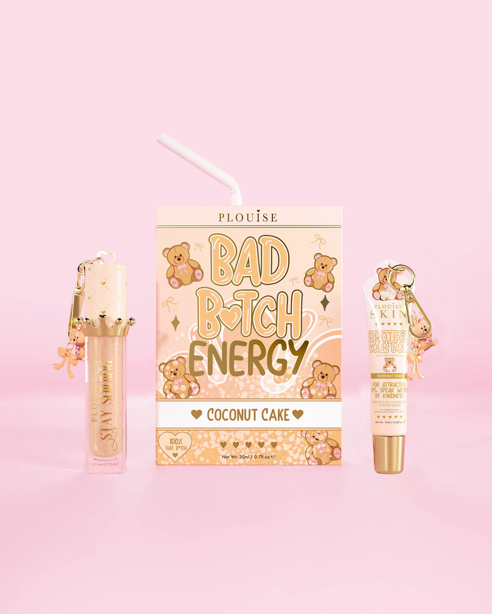 A P.Louise Teddy Glitter Bad Bitch Energy Lip Duo in coconut cake scent featuring a lip conditioner and lip oil against a pink background