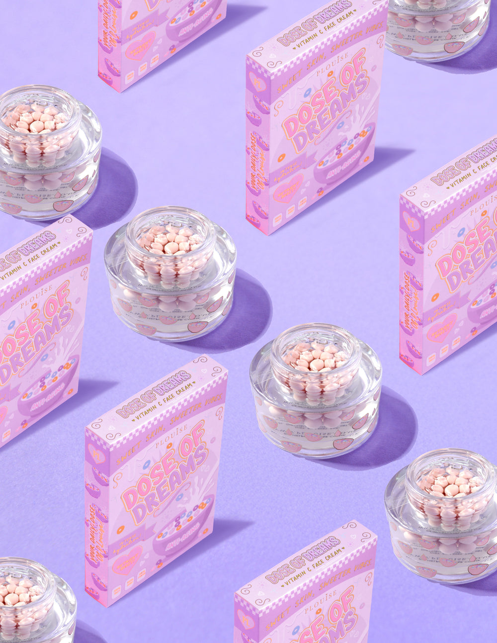 Recipiente transparente de P.Louise DOse of Dreams Viatmin C Capsule Cremă de față cu capsulă roz în ele înconjurate de cutii de cereale roz pe un fundal violet