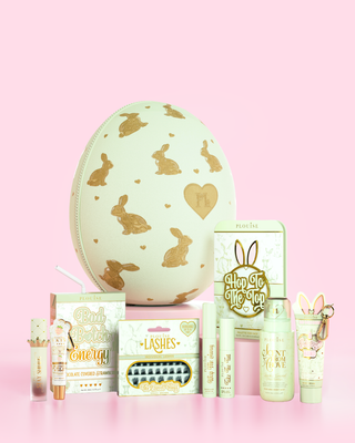 Collection of beauty products with a green decorative P.Louise easter egg on a pink background